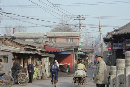 A hutong with bicycles and carts