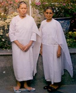 Two Buddist Nuns dressed in white robes