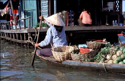 Cambodian woman and her floating vegatable stand