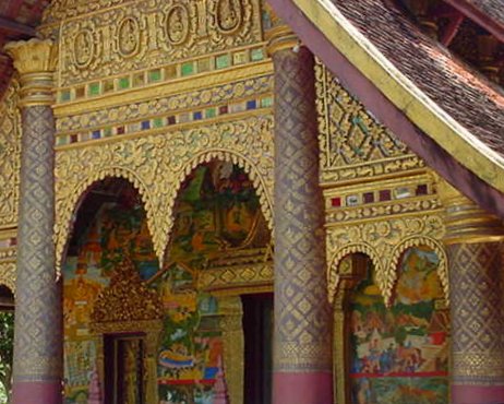 Wat Xieng Muan features a guilded facade with several wall-paintings near the door.