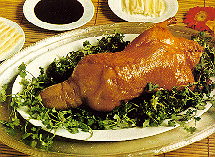 A plate of Roast Duck surrounded by dipping sauces